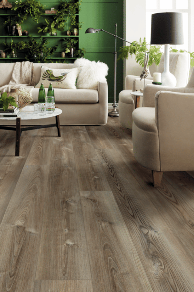 wood look luxury vinyl flooring in living room with white and green accents